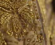 Get 100&#39;s of FREE Video Templates, Music, Footage and More at Motion Array: http://bit.ly/2SITwWM nnnGet this here: https://motionarray.com/stock-video/gold-beaded-embroidery-153509nnThis close-up video clip features the tiny ornate details of gold beading and embroidery. The camera comes into focus on gold beading on nude mesh fabric. The light hits the tiny beads causing them to sparkle and gleam. The beadwork creates leaves and floral blossoms. There are buds made of embroidered ribbon. The f