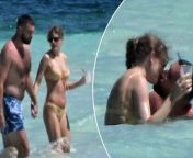 Taylor Swift and Travis Kelce were spotted kissing while enjoying their romantic vacation on the Bahamas’ Harbour Island on Thursday.&#60;br/&#62;&#60;br/&#62;The couple, who enjoyed private time at the &#36;15K-a-night Rosalita House estate, looked every bit in love as they waded into the crystal-clear water together, wrapping their arms around one another.&#60;br/&#62;